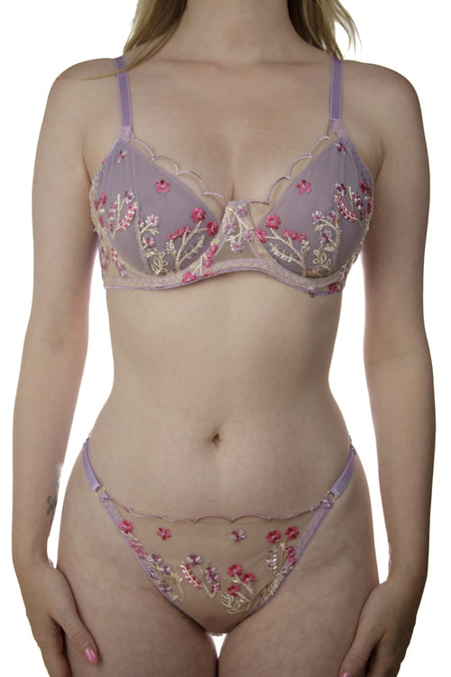 Fashionable model displaying a soft lilac lingerie set with pink highlights.